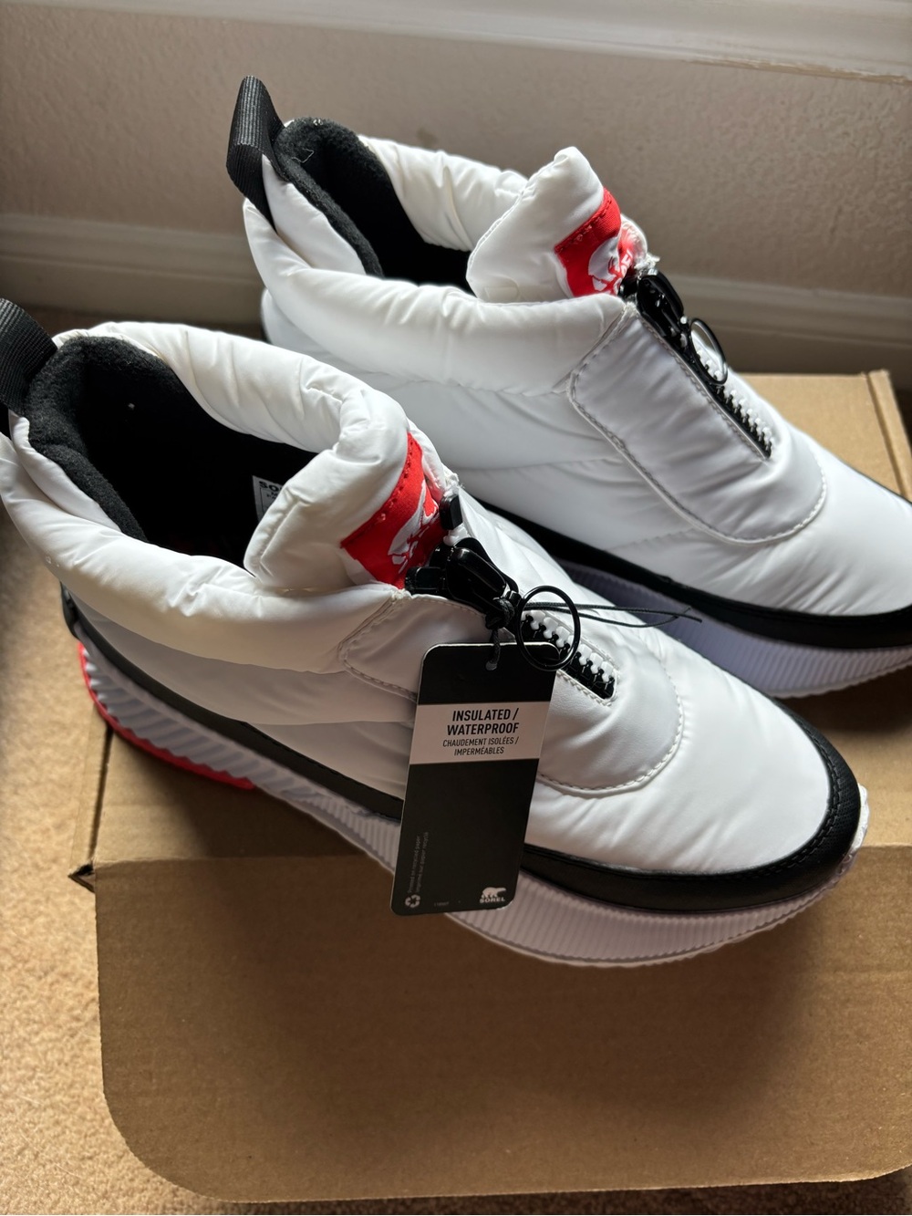 Sorel White Puffer Slip-On Sneakers with Red Accents. New. Never worn.